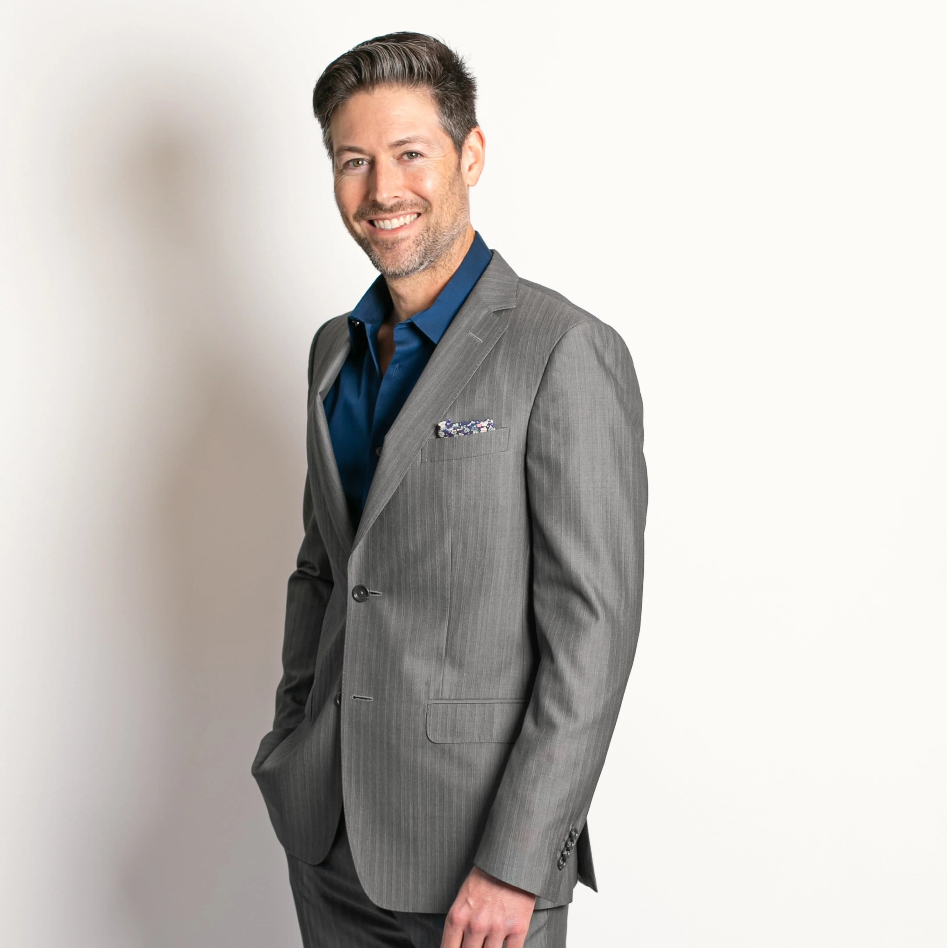 Michael Zick smiling in a gray suit